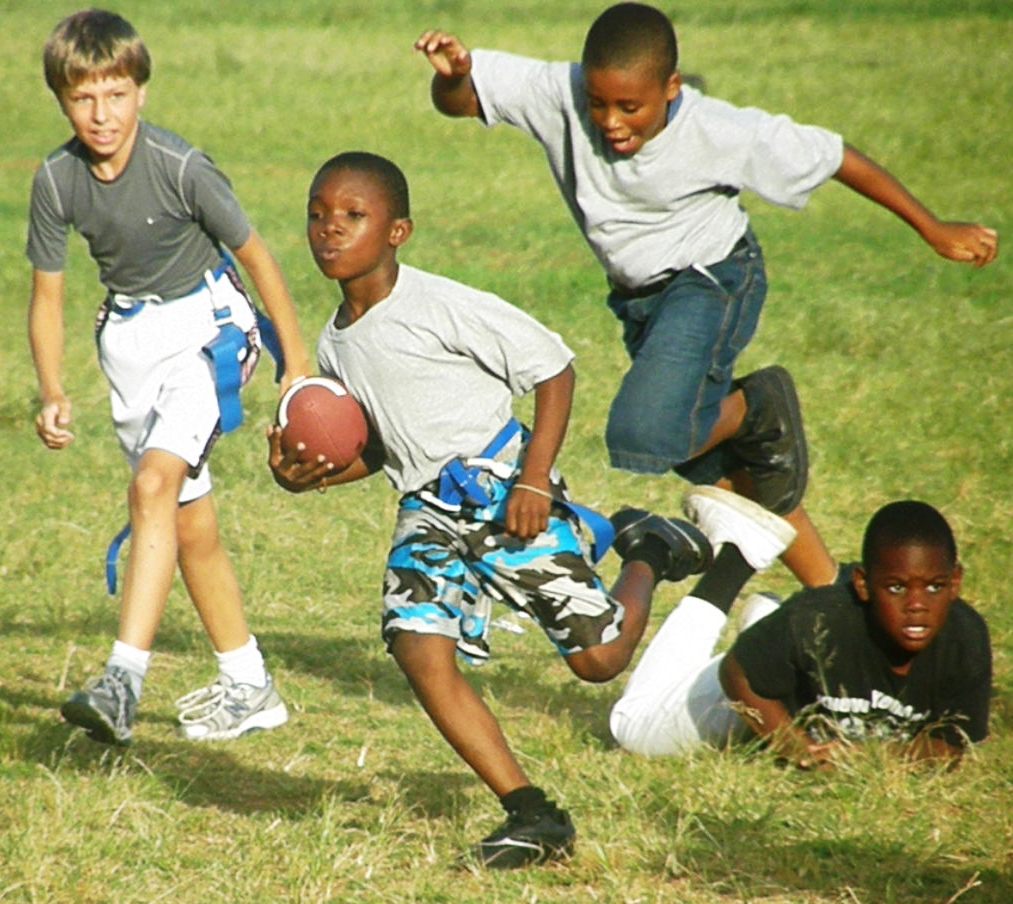 Children Playing Football In The Park