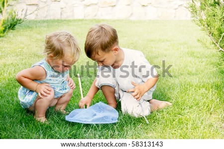 Little Children Playing In The Park Catching Butterflies