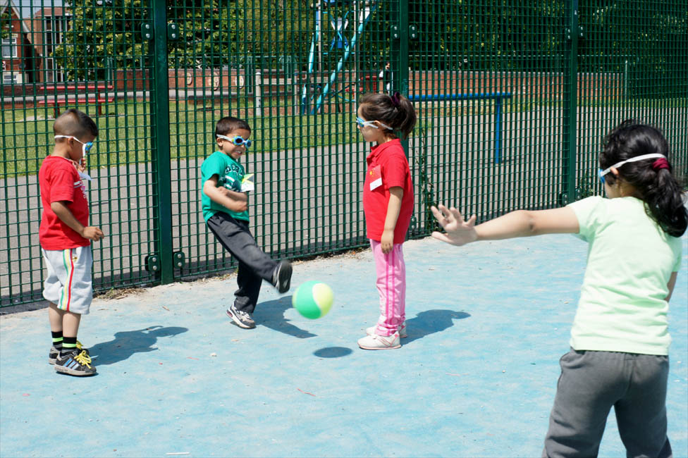 Children Playing Football At School